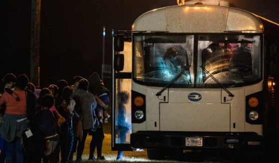 Migrants board a bus to be taken to a Border Patrol processing facility after crossing the Rio Grande into the U.S. on June 21, 2021, in La Joya, Texas.