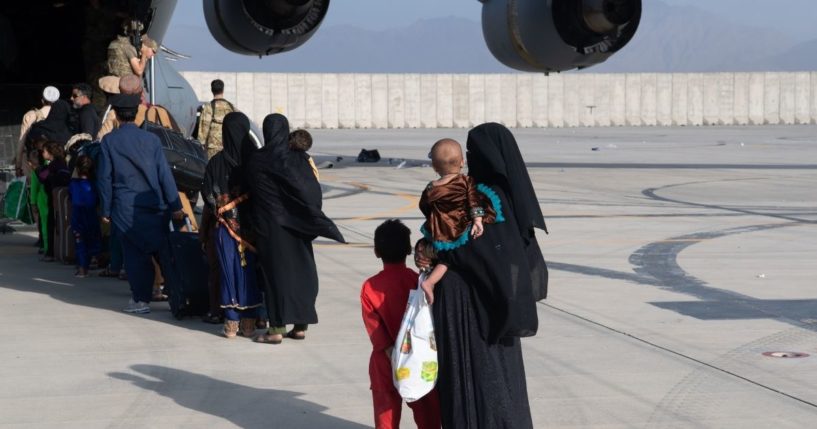 In this handout provided by U.S. Central Command Public Affairs, U.S. Air Force loadmasters and pilots assigned to the 816th Expeditionary Airlift Squadron, load passengers aboard a U.S. Air Force C-17 Globemaster III in support of the Afghanistan evacuation at Hamid Karzai International Airport on Aug. 24, 2021, in Kabul, Afghanistan.