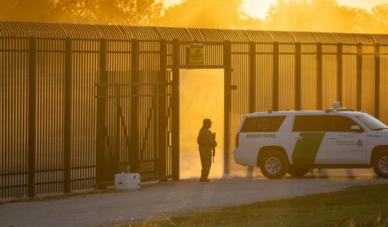 A Border Patrol vehicle drives through a gate in the border fence after U.S. Customs and Border Protection closed the point of entry between the U.S. and Mexico in response to an influx of migrants on Sept. 17, 2021, in Del Rio, Texas.