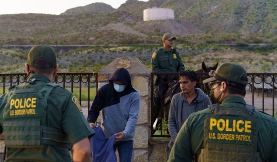 Detained migrants wait to be searched by U.S. Border Patrol agents in Sunland Park, New Mexico, on Wednesday.