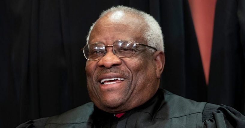 Supreme Court Associate Justice Clarence Thomas sits with fellow Supreme Court justices for a group portrait at the Supreme Court Building in Washington, D.C., in 2018.