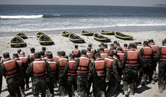 Navy SEAL trainees participate in a Hell Week exercise on a beach in Coronado, California, in August 2010.