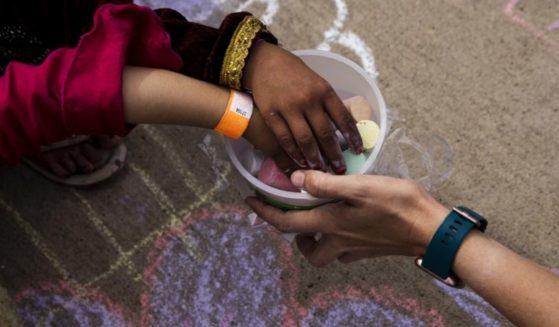 Afghan children are seen playing with chalk at Fort McCoy in Wisconsin in a Tuesday photo provided by the U.S. Army.