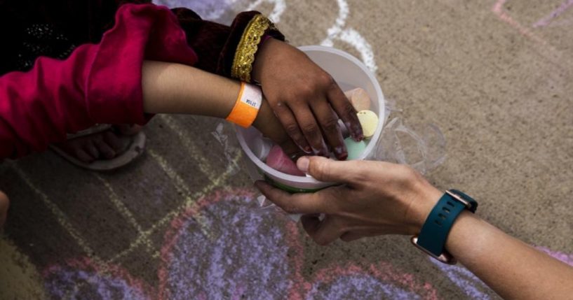 Afghan children are seen playing with chalk at Fort McCoy in Wisconsin in a Tuesday photo provided by the U.S. Army.