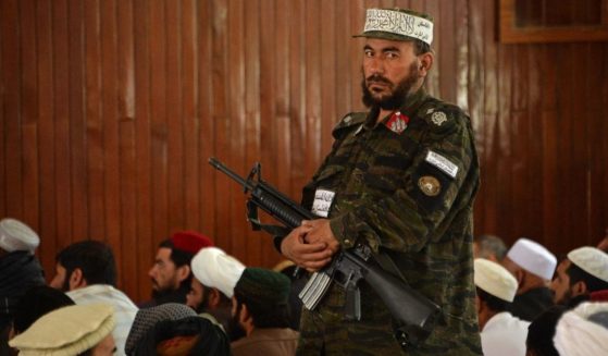 A Taliban fighter stands guard Friday during prayers at a Kabul, Afghanistan, mosque.