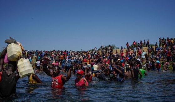 A group of Haitian migrants is seen crossing the Rio Grande on Sept. 19.