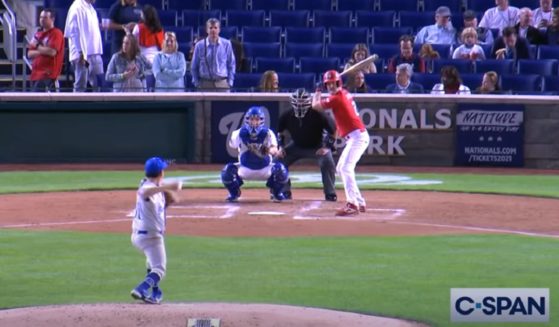 Florida Rep. Greg Steube takes the pitch that he will launch into a home run Wednesday at the annual Congressional Baseball Game.