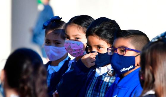 A student adjusts her mask at St. Joseph Catholic School in La Puente, California, on Nov. 16, 2020.