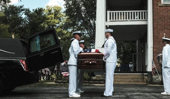 Members of the Navy handle a coffin containing the body of Corpsman Max Soviak on Wednesday in Berlin Heights, Ohio. Soviak was one of 13 U.S. service members killed in Kabul, Afghanistan, on Aug. 26, 2021.