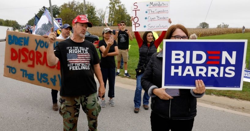 Pro- and anti-Biden protesters are seen in Howell, Michigan, as the president arrives for a visit on Tuesday.