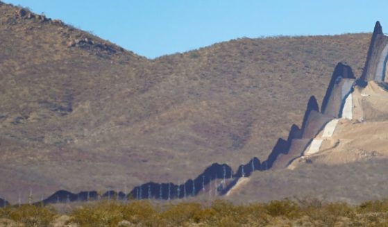 The rugged desert landscape of northern Mexico (left) is shown near the United Stated border wall near Douglas, Arizona.