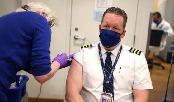 United Airlines pilot Steve Lindland receives a COVID-19 vaccine from RN Sandra Manella at United's onsite clinic at O'Hare International Airport in Chicago on March 9.
