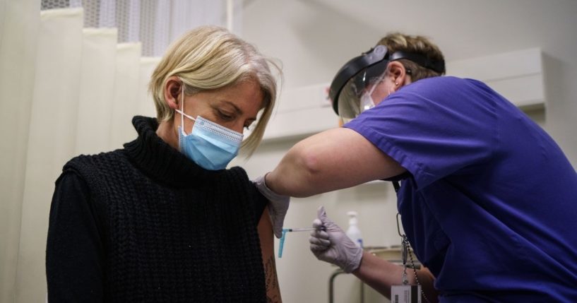 A woman receives the first of two doses of the Pfizer-BioNtech COVID-19 vaccine at Östra Hospital in Gothenburg, Sweden, on Jan. 14.