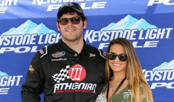 John Wes Townley and then-girlfriend Laura Bird pose with the Keystone Light Pole Award after qualifying for the NASCAR Camping World Truck Series Careers for Veterans 200 at Michigan International Speedway in Brooklyn, Michigan, on Aug. 27, 2016.