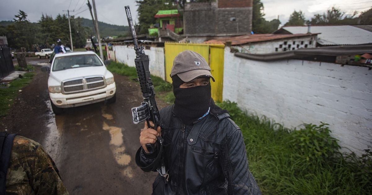 Members of the self-defense group Pueblos Unidos carry out guard duties in protection of avocado plantations, whipped by drug cartels that dominate the area, in Ario de Rosales, state of Michoacan, Mexico, on July 8.
