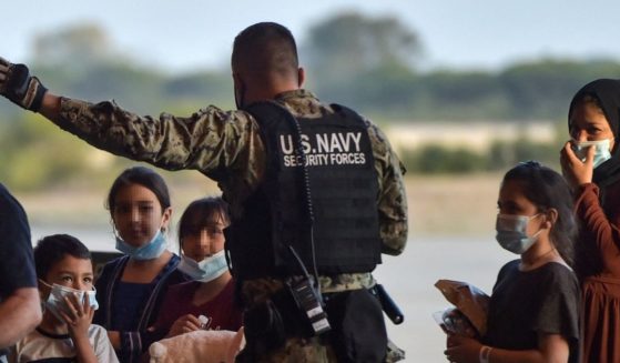 Refugees receive instructions from a U.S. navy soldier as they disembark from a US air force aircraft after an evacuation flight from Kabul at the Rota naval base in Rota, southern Spain, on Aug. 31.