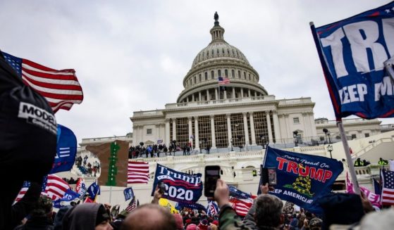 Trump supporters stand outside the U.S. Capitol following a rally with then-President Donald Trump on Jan. 6, in Washington, D.C.