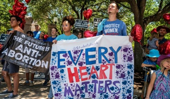 Pro-life protesters stand near the gate of the Texas state capitol in Austin on May 29, 2021.