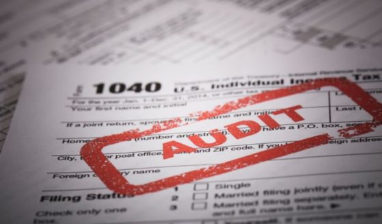 A stock photo shows a red stamp on a 1040 US individual income tax return.