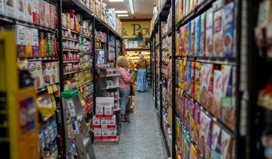An employee takes inventory at a grocery store on Aug. 17 in New York City.