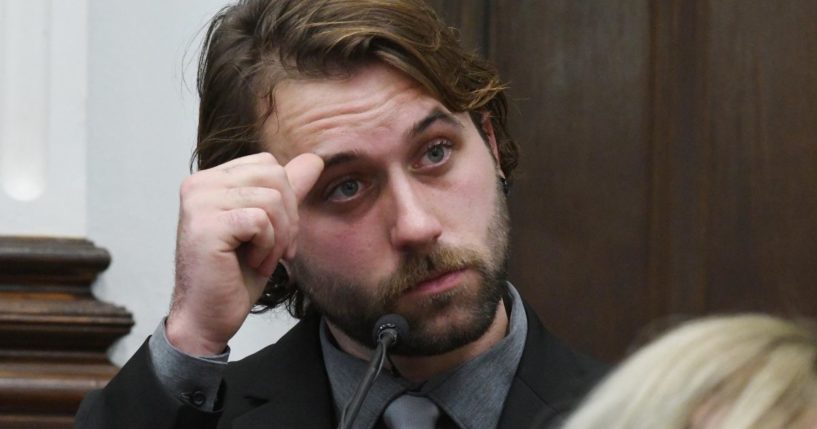 Gaige Grosskreutz watches video as he testifies about being shot in the right arm during the Kyle Rittenhouse trial at the Kenosha County Courthouse on Monday in Kenosha, Wisconsin.