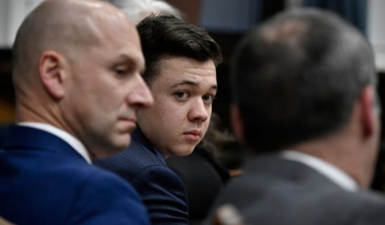 Kyle Rittenhouse, center, looks over to his attorneys as the jury is dismissed for the day during his trial at the Kenosha County Courthouse on Thursday in Kenosha, Wisconsin.