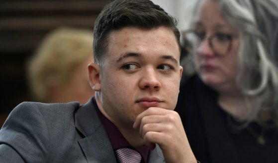 Kyle Rittenhouse sits with his attorneys after a lunch break at the Kenosha County Courthouse in Kenosha, Wisconsin, on Nov. 9.