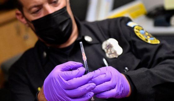 A Culver City Fire Department paramedic prepares a syringe with a dose of the Johnson & Johnson COVID-19 vaccine on Aug. 5 in Culver City, California.