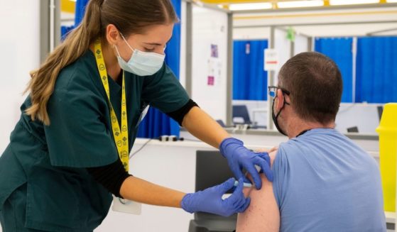 A man is vaccinated at the Cardiff Bay mass vaccination center on Wednesday in Cardiff, Wales.