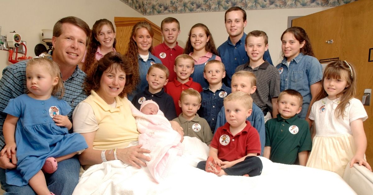 Michelle Duggar, left center, and husband Jim Bob, second from left, are seen surrounded by their 17 children after the birth of their 17th child on Aug. 2, 2007; the family was made famous on the popular TLC show "19 Kids and Counting."