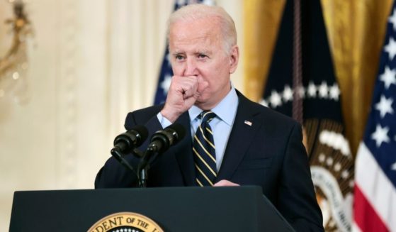 President Joe Biden coughs as he delivers remarks about the Build Back Better legislation's new rules around prescription drug prices in the East Room of the White House on Monday in Washington, D.C.