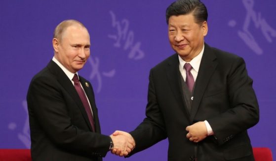 Russian President Vladimir Putin, left, shakes hands with Chinese President Xi Jinping on April 26, 2019, in Beijing.