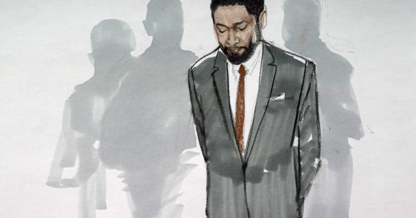 In this courtroom sketch, actor Jussie Smollett stands with his legal team in a Leighton Criminal Courthouse courtroom in Chicago, Illinois, on Dec. 9 after a jury found him guilty on five of six charges he staged a racist, anti-gay attack on himself and lied to police about it.