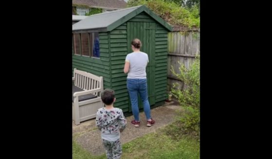 Cheryl Binmore prepares to step inside the shed her husband renovated in her backyard in Chandler's Ford, Hampshire.