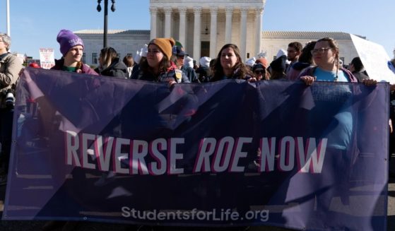 Pro-Life protesters stand outside the U.S. Supreme Court on Dec. 1, 2021 as the court prepares to hears a case over a 2018 Mississippi law banning abortions after 15 weeks.