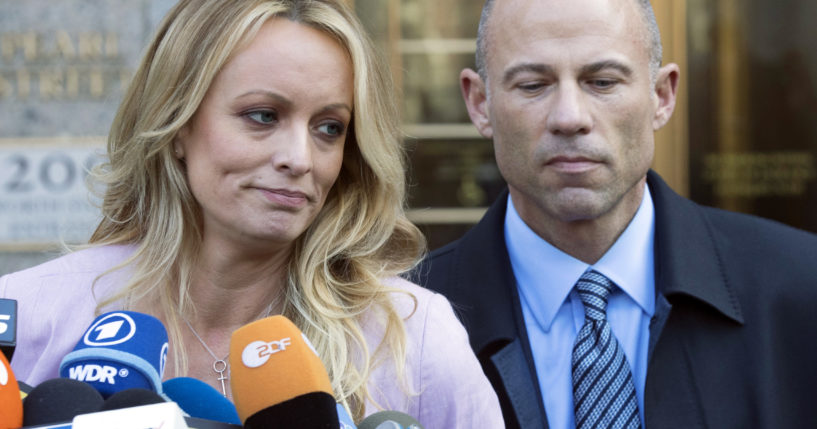 Porn actress Stormy Daniels, accompanied by her attorney, Michael Avenatti, talks to the media as she leaves federal court in New York on April 16, 2018. On Friday, Avenatti was convicted of charges he cheated Daniels out of nearly $300,000.