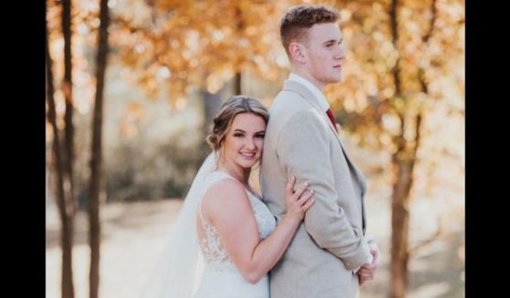 Bride Kelsey Kulick poses with groom Michael Kulick.