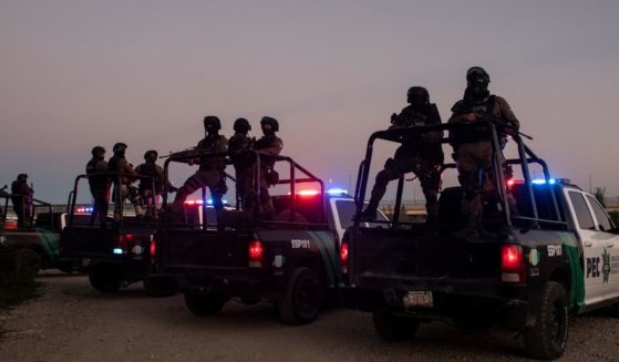 A group of Mexican police set up in Ciudad Acuna, Mexico, on Sept. 23, 2021, near the border of Del Rio, Texas.