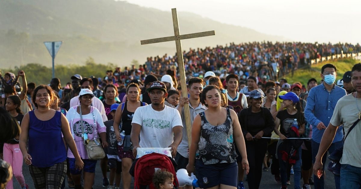 A large group of migrants march through Huixtla, Chiapas state, Mexico, on Oct. 27, 2021, as they make their way towards the U.S. border, increasing their numbers along the way.