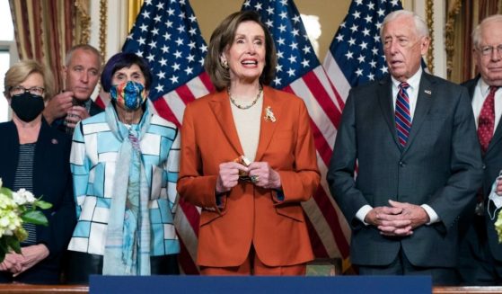 Speaker of the House Nancy Pelosi, center, stands with House Democratic representatives - from left to right Chellie Pingree of Maine, Sean Maloney of New York, Rosa DeLauro of Connecticut, Steny Hoyer of Maryland, and David Price of North Carolina - during an enrollment ceremony for continued government funding on Dec. 3, 2021.