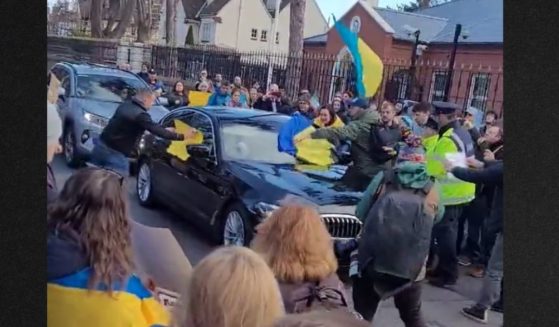 Protesters in Ireland mob the Russian ambassador's vehicle with Ukranian flags as it attempts to pass.