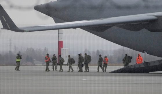 U.S. soldiers from the 82nd Airborne Division leave a plane with their equipment after landing at the Rzeszow-Jasionka airport in Poland on Sunday.