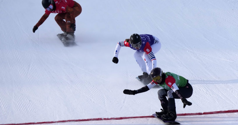 The United States' Lindsey Jacobellis (5) crosses the finish line to win the gold medal in snowboard cross Wednesday in Zhangjiakou, China, during the 2022 Winter Olympics.