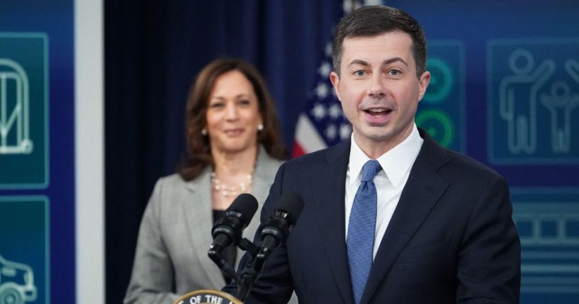 Vice President Kamala Harris, left, listens as Transportation Secretary Pete Buttigieg speaks in the South Court Auditorium of the Eisenhower Executive Office Building in Washington, D.C., on Monday.