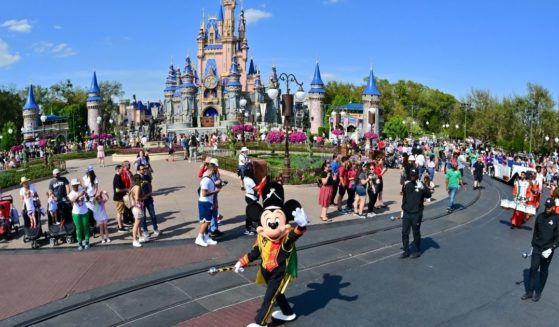 Mickey Mouse waves during a parade at Walt Disney World Resort on March 3, 2022, in Lake Buena Vista, Florida. Four Disney employees have been arrested in an undercover operation by the Polk County Sheriff’s Office in the state.