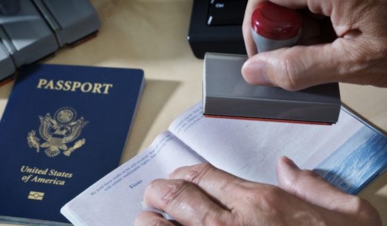 A U.S. border agent inspects a passport.