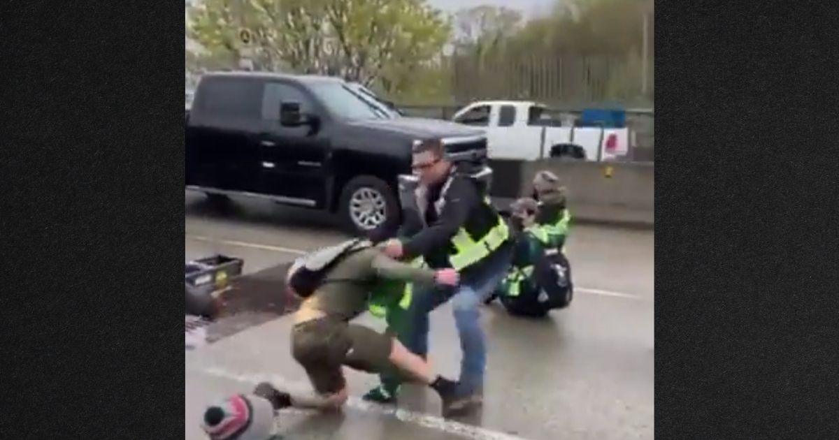 Commuters dragged climate-change protesters out of traffic lanes Thursday in Vancouver, BC.