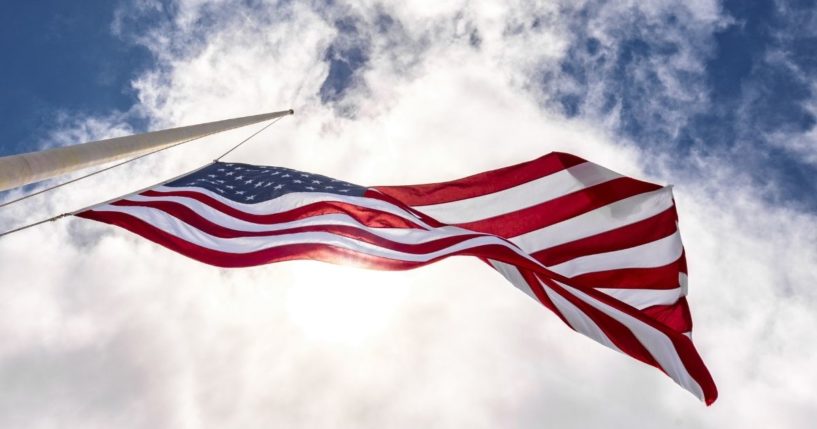 An American flag flies in the above stock image.