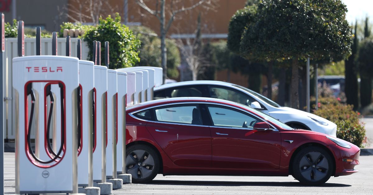 Two Tesla electric vehicles recharge at a supercharging station in Petaluma, California, on Monday.