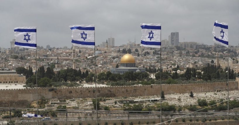 Israeli flags flutter at a military cemetery on the Mount of Olives in Jerusalem on Wednesday.